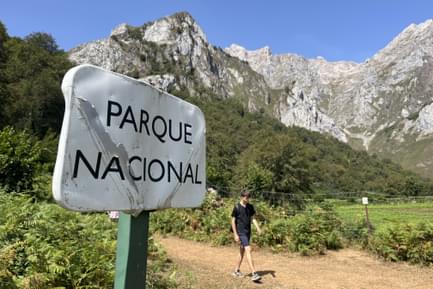 hiking past national park sign in picos de europa