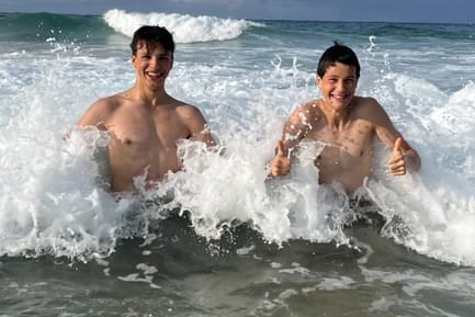 teenage boys swimming in sea in northern spain
