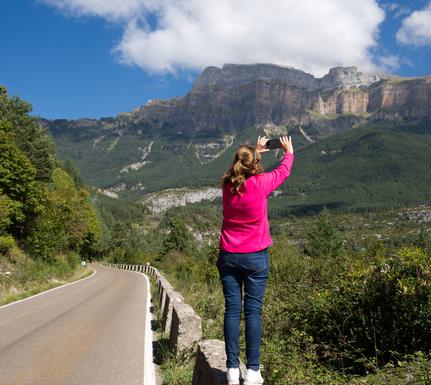 Spain pyrenees woman by road istock