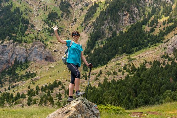 smiling woman hiking in spanish pyrenees