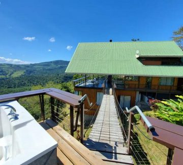 a view of a hot tub and house perched above the clouds in costa rica's central valley