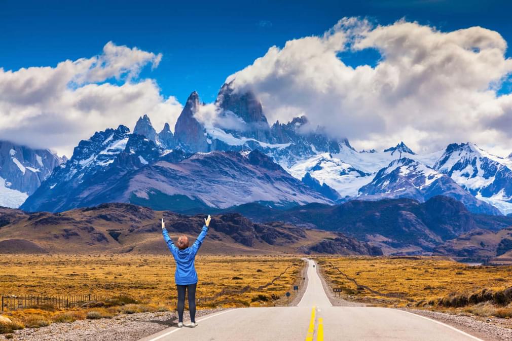 Argentina patagonia woman delighted natural beauty raised her hands the highway leads to the snow capped peaks of mount fitzroy20180829 76980 a6ndlt