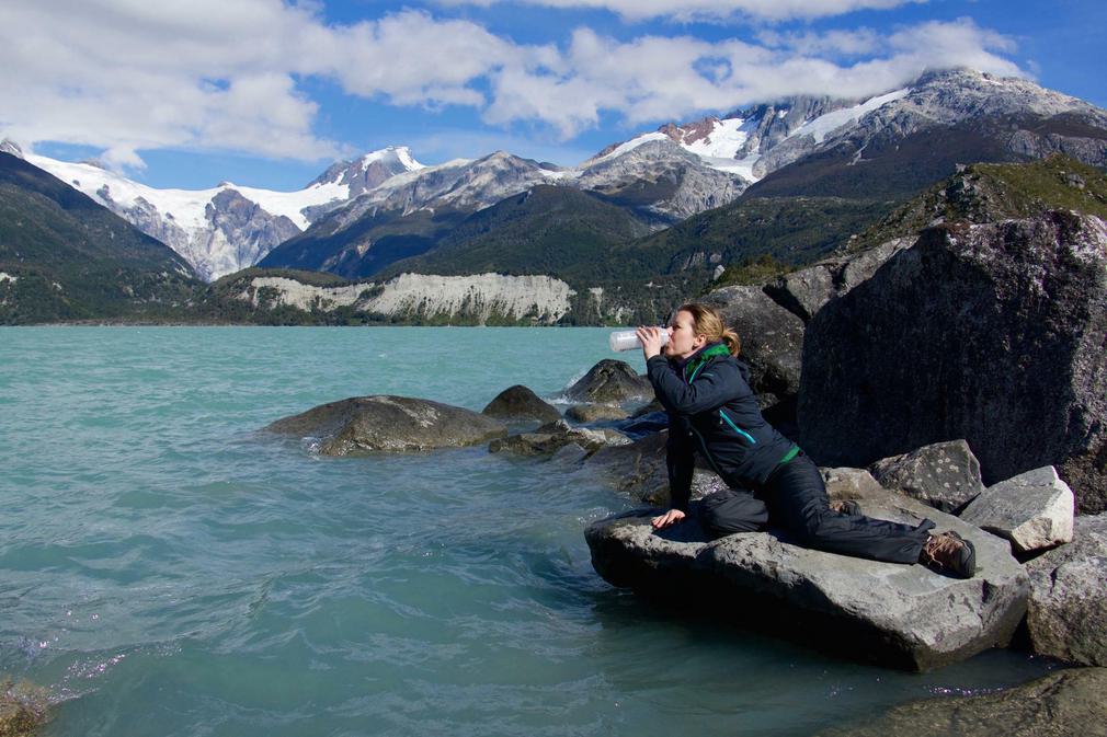 Chile patagonia carretera austral woman drinking from leones lagoon flipped c pura aventura thomas power